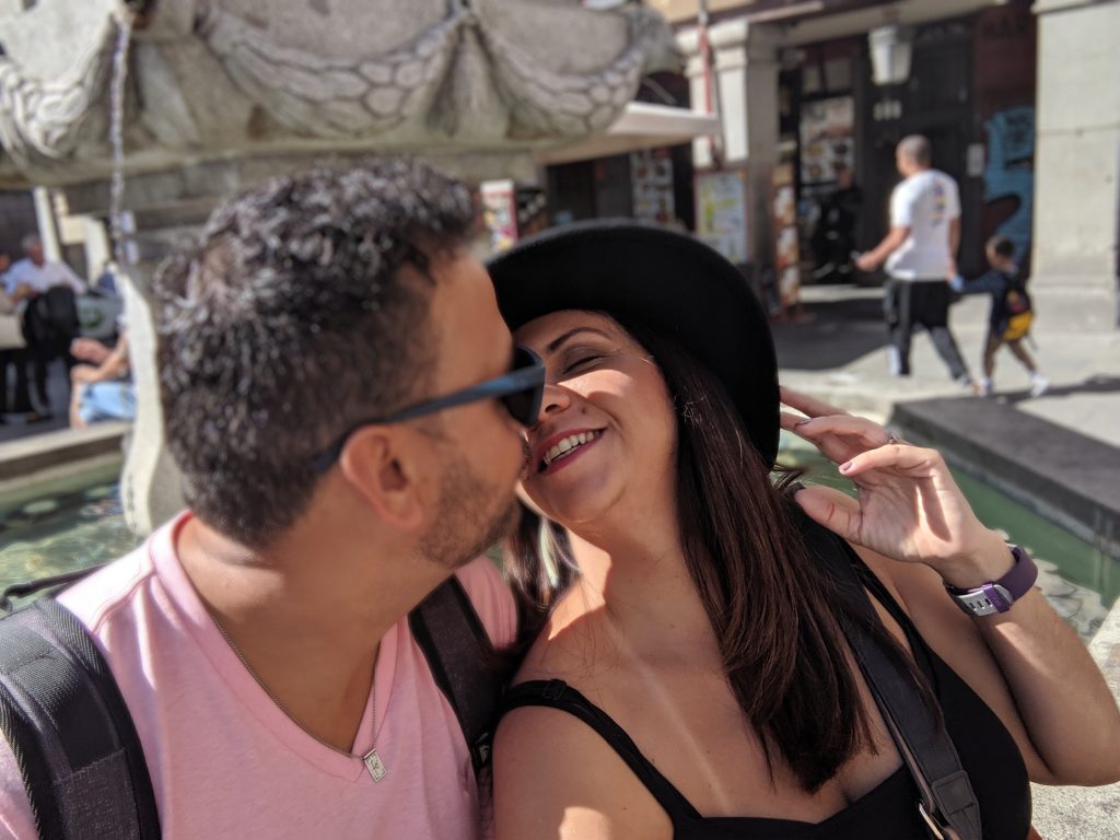couple kissing while traveling in Madrid Spain